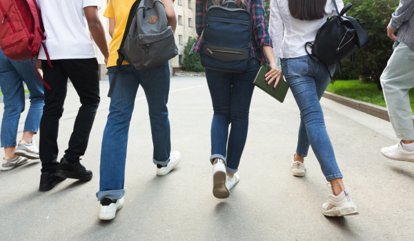 leg view of 4 students walking away