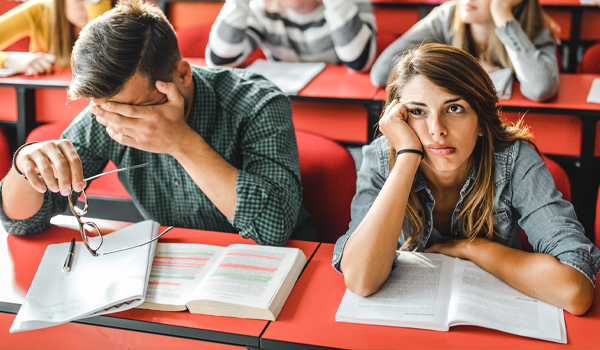 two students with bored looks on their faces