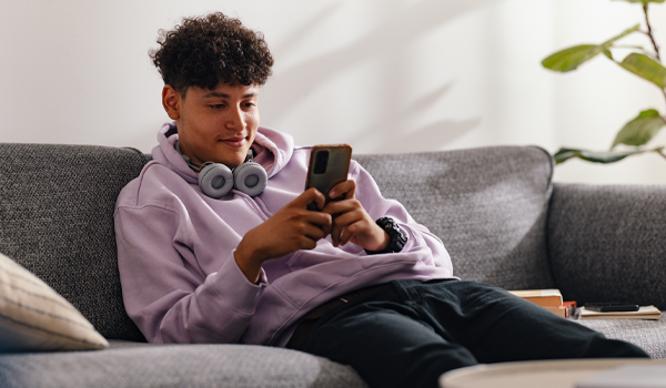 student lounges with cellphone