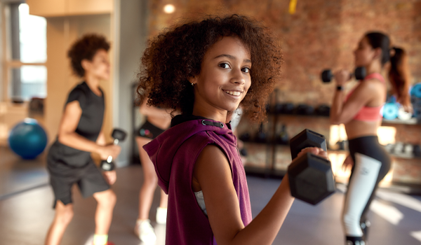 A young student lifting weights.