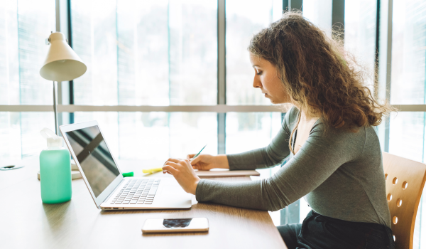 student types at a laptop